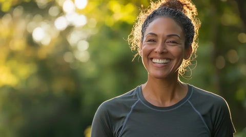 woman smiling with blurred tress in background