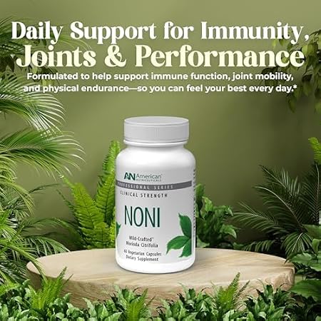 A white bottle of Noni dietary supplement by American Nutriceuticals, displayed on a wooden slice pedestal surrounded by green foliage. The background is a soft olive green with promotional text at the top reading 'Daily Support for Immunity, Joints & Performance'.