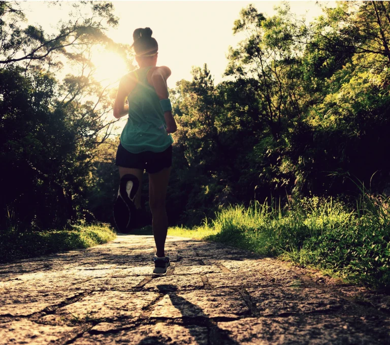 runner-athlete-running-on-forest-trail-woman